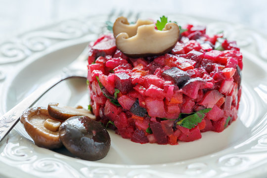 Traditional Russian salad with marinated mushrooms.