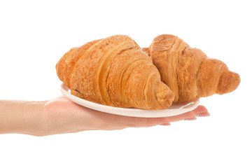 Croissants on a white plate n hand