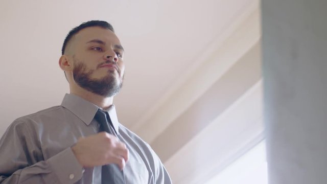 Nervous hispanic man practicing introduction in front of mirror