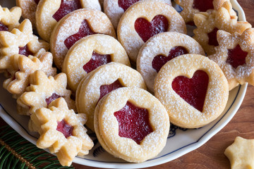 Linzer Christmas cookies filled with strawberry jam on a plate