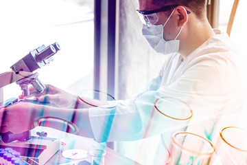 double exposure of scientist or doctor using microscope with science laboratory test tube