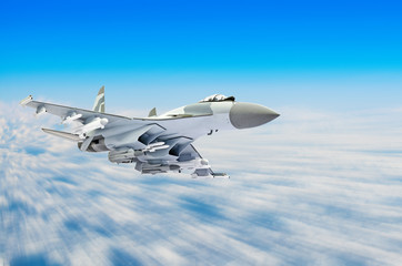 Military fighter aircraft at high speed, flying high in the sky.