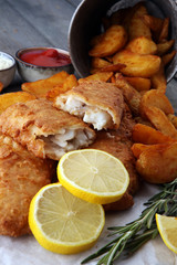 traditional British fish and chips with potato and lemon