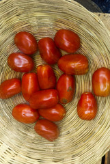Red tomato in a natural fiber basket