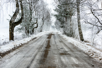 car tire tracks on winter road