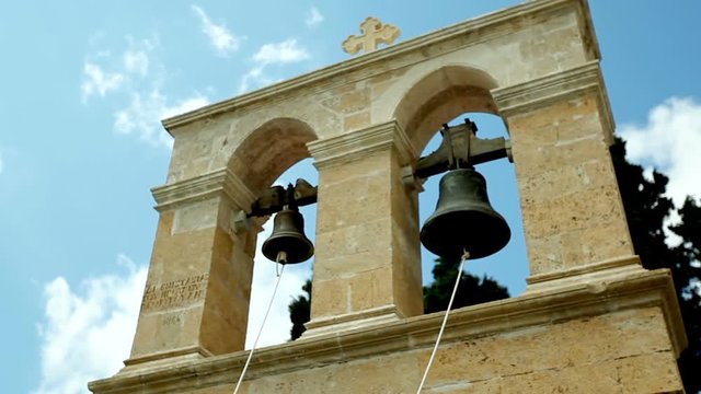 two bells against the blue sky. Visit to the monasteries and churches of Greece.