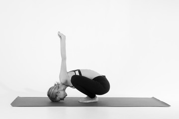 Sporty young woman doing yoga practice isolated on white background - concept of healthy life and...