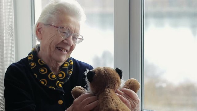 Happy grandmother with a toy in her hands. The concept of positive in old age
