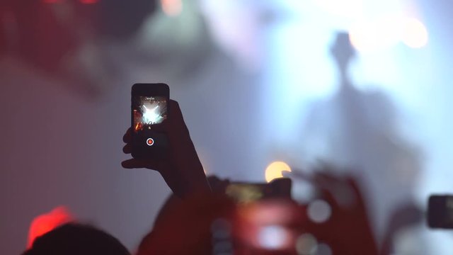 Man recording concert with smartphone