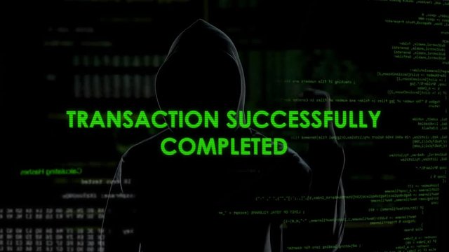 Black hood man making online transaction, money laundering, financial fraud