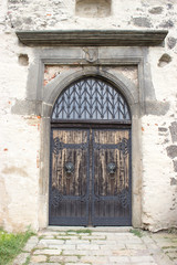 Fototapeta na wymiar Entrance wooden gate to the castle with knockers