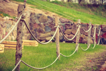 Old fashioned fence made of sticks and cord