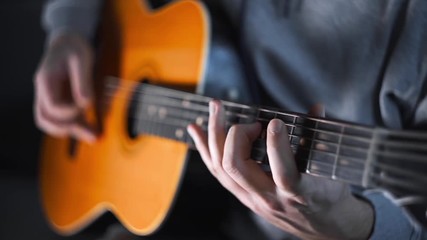 Guitar player plays random chords on the acoustic western guitar with steel strings ,exercises and arpeggios, video with sound, plaing the guitar