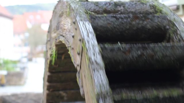 Vinatge waterwheel is spinning fast in traditional city