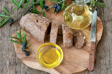 Olives and olive oil on a wooden table