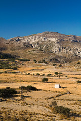 Rural landscape with dry field in a hot summer day  in the mountains of Crete island,  Greece, Mediterranean.