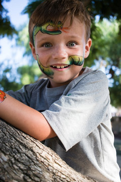 Boy in Tree with Face Paint