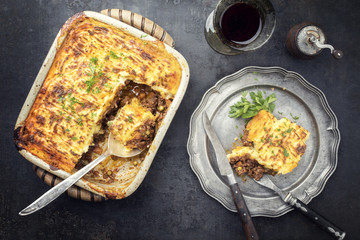 English shepherds pie as top-view on a pewter plate and backing dish