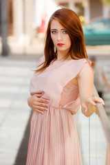 Woman in long dress walking on city street