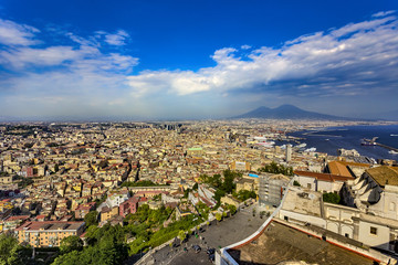 Obraz premium Italy. Cityscape of Naples (historic centre is a UNESCO World Heritage Site) seen from Castle Sant'Elmo. There is Certosa e Museo di San Martino in the right and Mount Vesuvius in the background