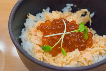 Ikura - Salmon and Roe over white Rice in stone bowl