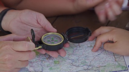 Kids at outdoor school looking at compass - Powered by Adobe