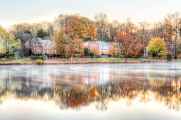 Sunrise on Braddock lake in Burke, Virginia, USA, Fairfax county with reflection of townhouses,...