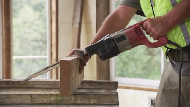 Construction worker cutting board with saw