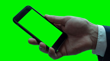 Isolated businessman hand with black smartphone. Green screen.