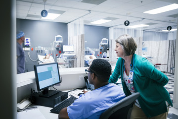 Doctor and nurse working on computer in hospital