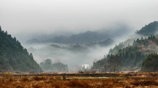 Time lapse of Wuyuan village in morning, beautiful clouds moving up and down in mountains, amazing rural landscape.