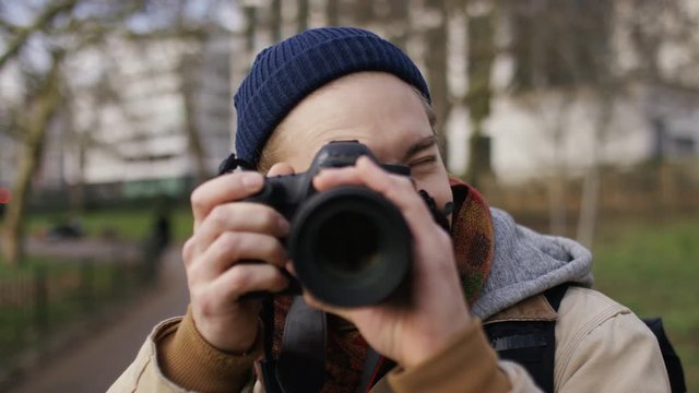 Handsome photographer takes photos of the viewer 