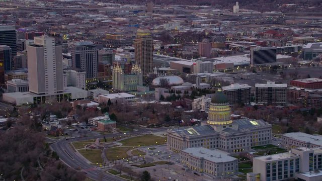Salt Lake City, Utah circa-2017, Aerial zoom out from Utah State Capitol to reveal city and mountains at sunrise