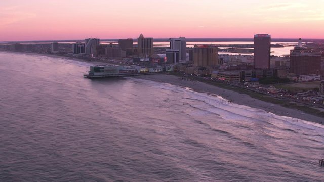 Atlantic City, New Jersey circa-2017, Aerial view of Atlantic City beach and piers at sunset.  Shot with Cineflex and RED Epic-W Helium. 