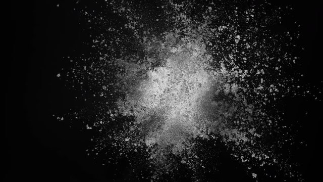 White powder exploding on black background in super slow motion, shot with Phantom Flex 4K