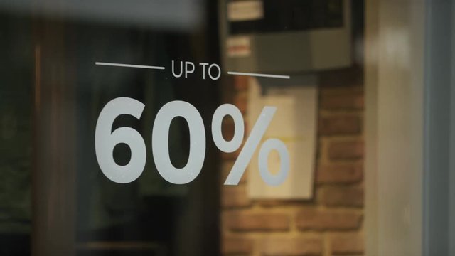 Sale sign showing a discount of goods in a shop window