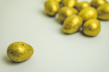 Golden Chocolate Easter Eggs on a white background