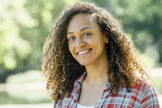 Portrait Of Smiling Mixed Race Woman Outdoors