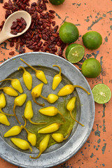 yellow pickled chili peppers cool green limes and spicy dried red Pequin chili peppers