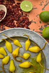 yellow pickled chili peppers cool green limes and spicy dried red Pequin chili peppers