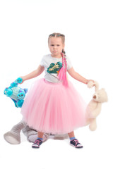 little girl posing together with big toys