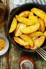 Fried potatoes in an iron pan. Top view