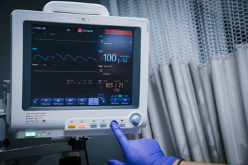 Technician pressing button on monitor