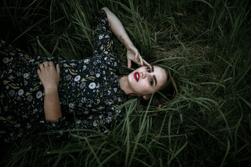 Portrait of beautiful woman laying in grass