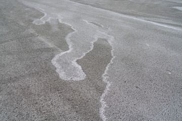 winter ice melting salt on the ground, pattern as background