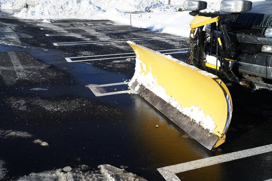 Snowplow In The Parking Lots With Snow Removed