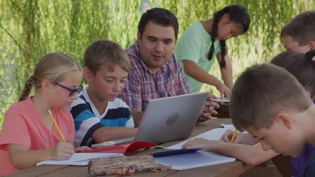 Kids at outdoor school using laptop computer