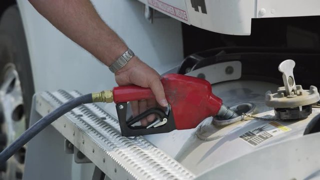 Closeup shot of truck driver filling up fuel tank.  Fully released for commercial use.