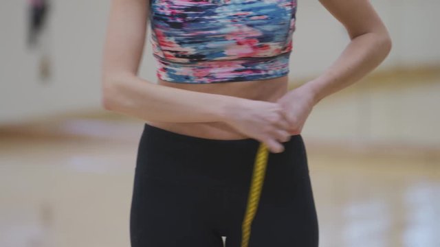 Woman at gym measures waist