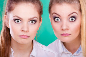 Two young women looking shocked